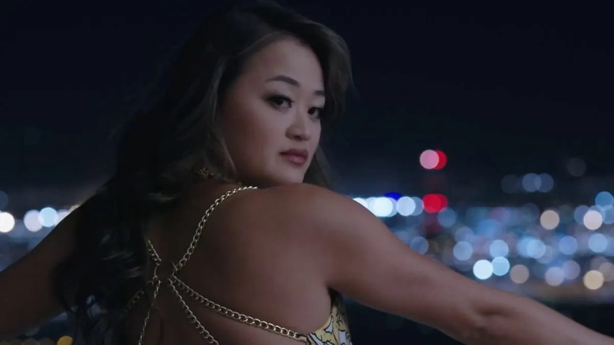 MGM Signature lifestyle campaign · a woman in a chain-detail gown against city lights at night