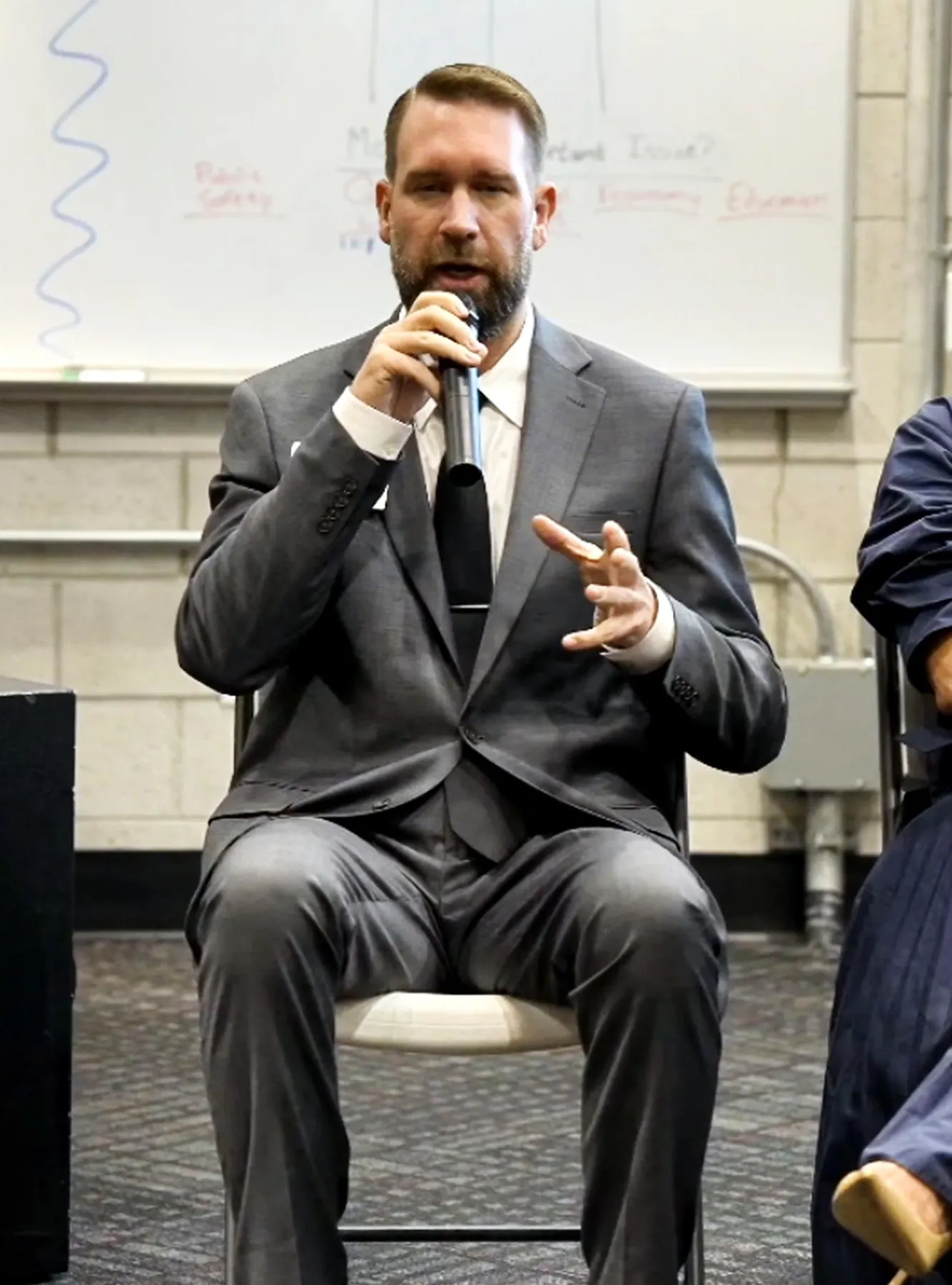 Austin Beaumont speaking into a microphone at the District Court panel, Across the Aisle Vol. 5, UNLV
