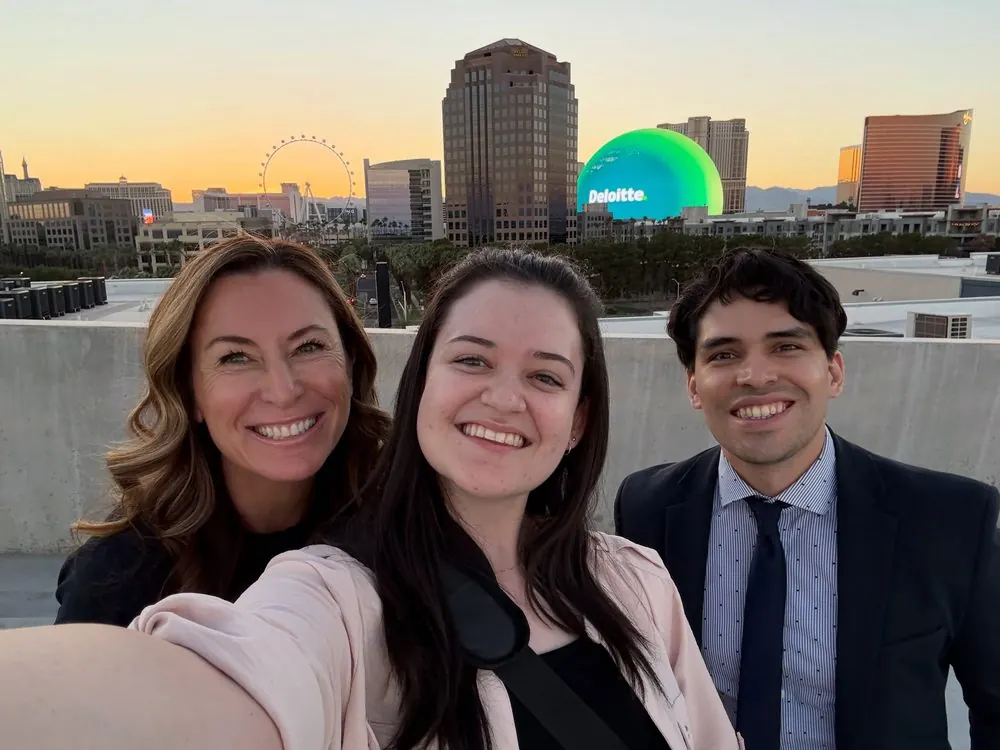 Marlon A. Medina, Enessa Ossa and Alexis Michaud on the rooftop of the GMS content studio at sunset, the Sphere lit behind them