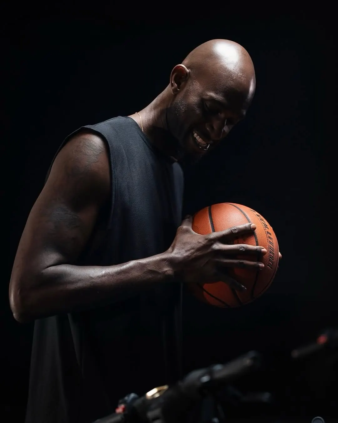 Kevin Garnett holding a basketball under studio light during a GMS production