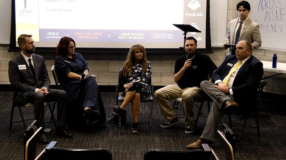 The District Court panel seated at Across the Aisle Vol. 5, UNLV, with the moderator standing at right